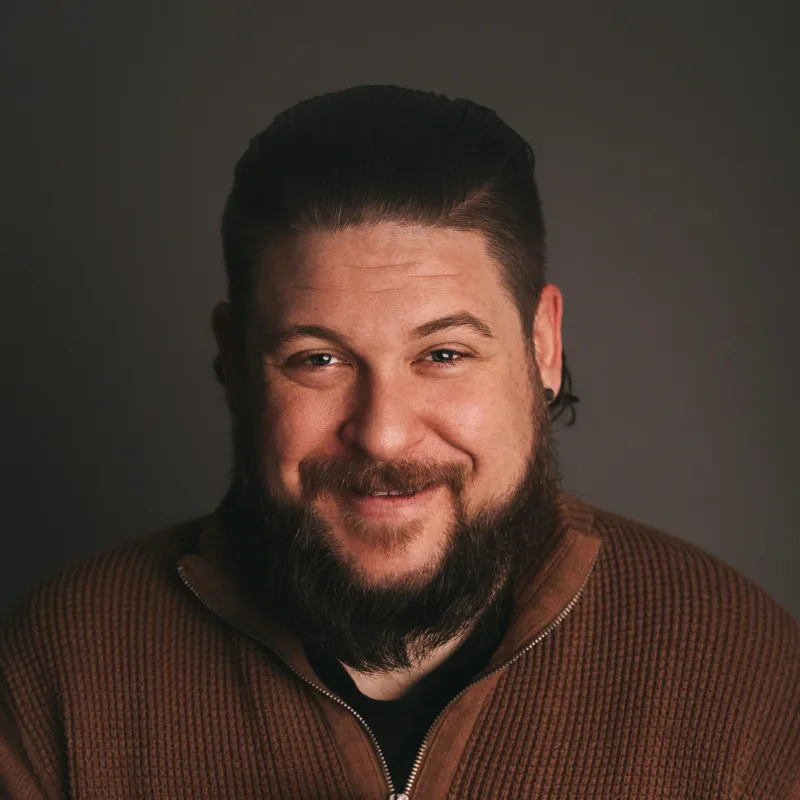 Trent Dutt smiling in a studio portrait